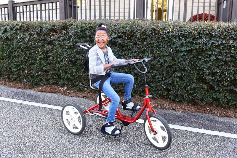 Girl riding a tricycle bike