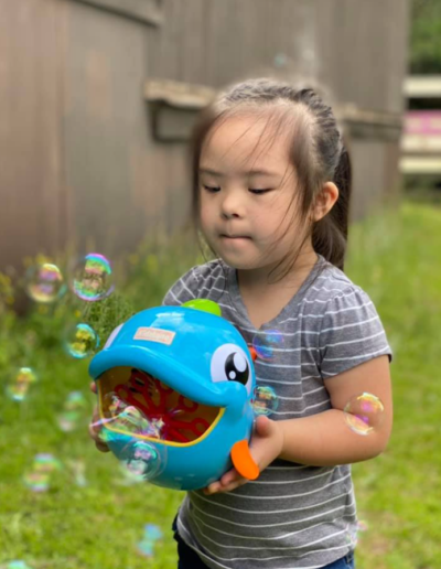 Girl with bubble toy at Sumlar Therapy Services, Inc