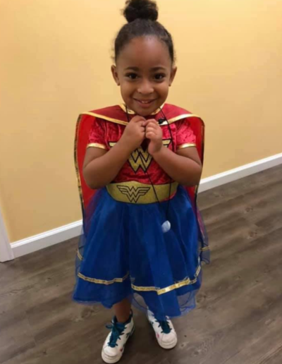 Girl in wonder woman costume at Sumlar Therapy Services, Inc