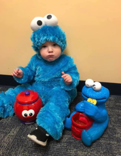 Baby in Cookie Monster costume at Sumlar Therapy Services, Inc