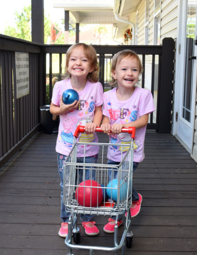Two girls with a toy shopping cart at Sumlar Therapy Services, Inc